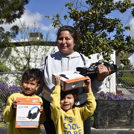 A family picking up their computer from Computers 2 Kids
